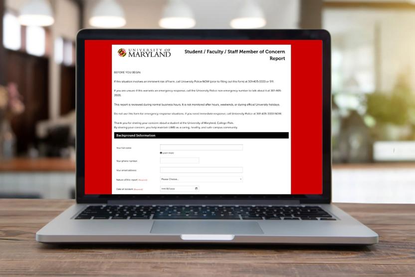 Laptop open to the Dean of Students' online reporting form for submitting a concern.